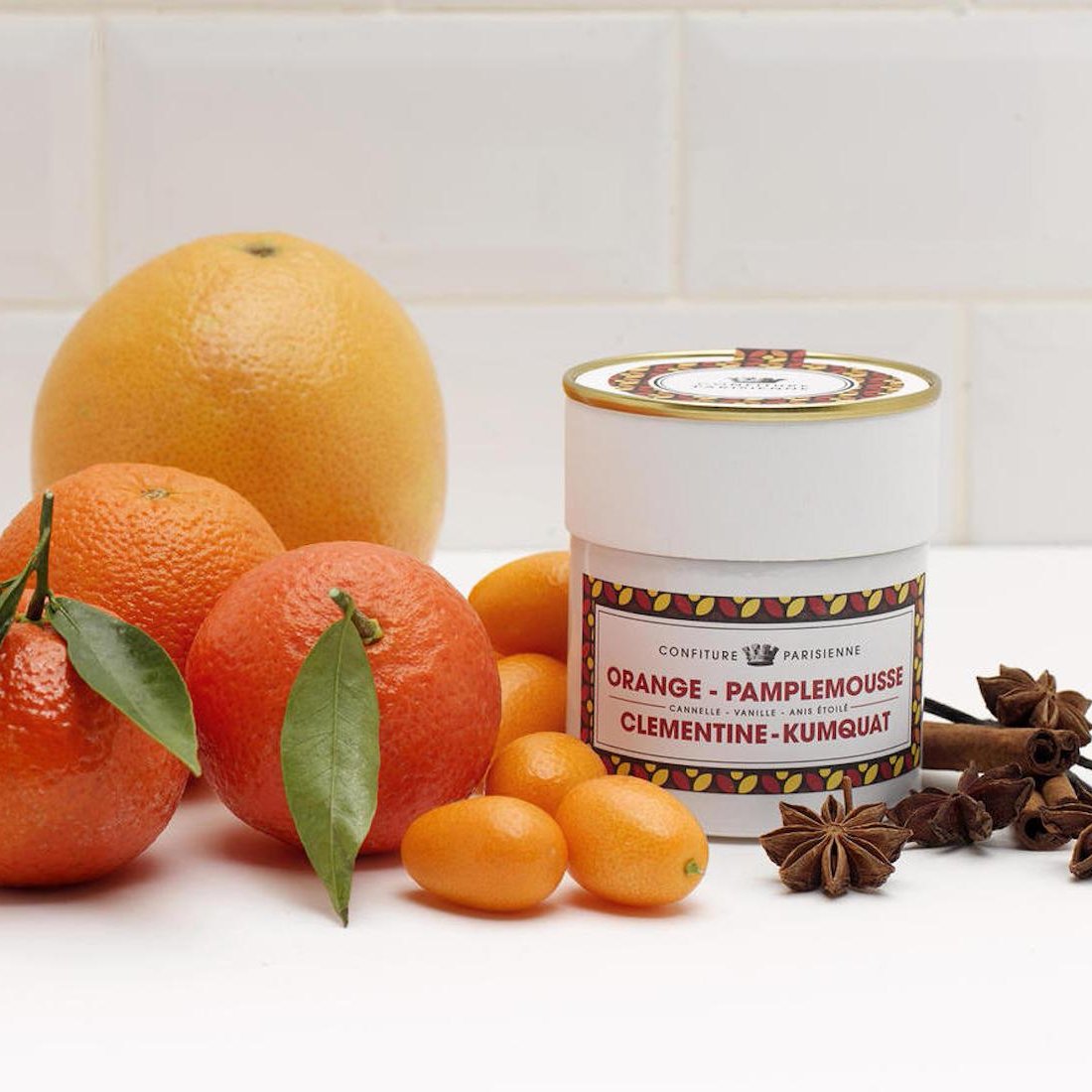 Four citrus fruit: orange, grapefruit, clementine, and kumquat